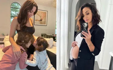 Pregnant woman in black tank and blazer; kids kiss her belly; mirror selfie showing baby bump.