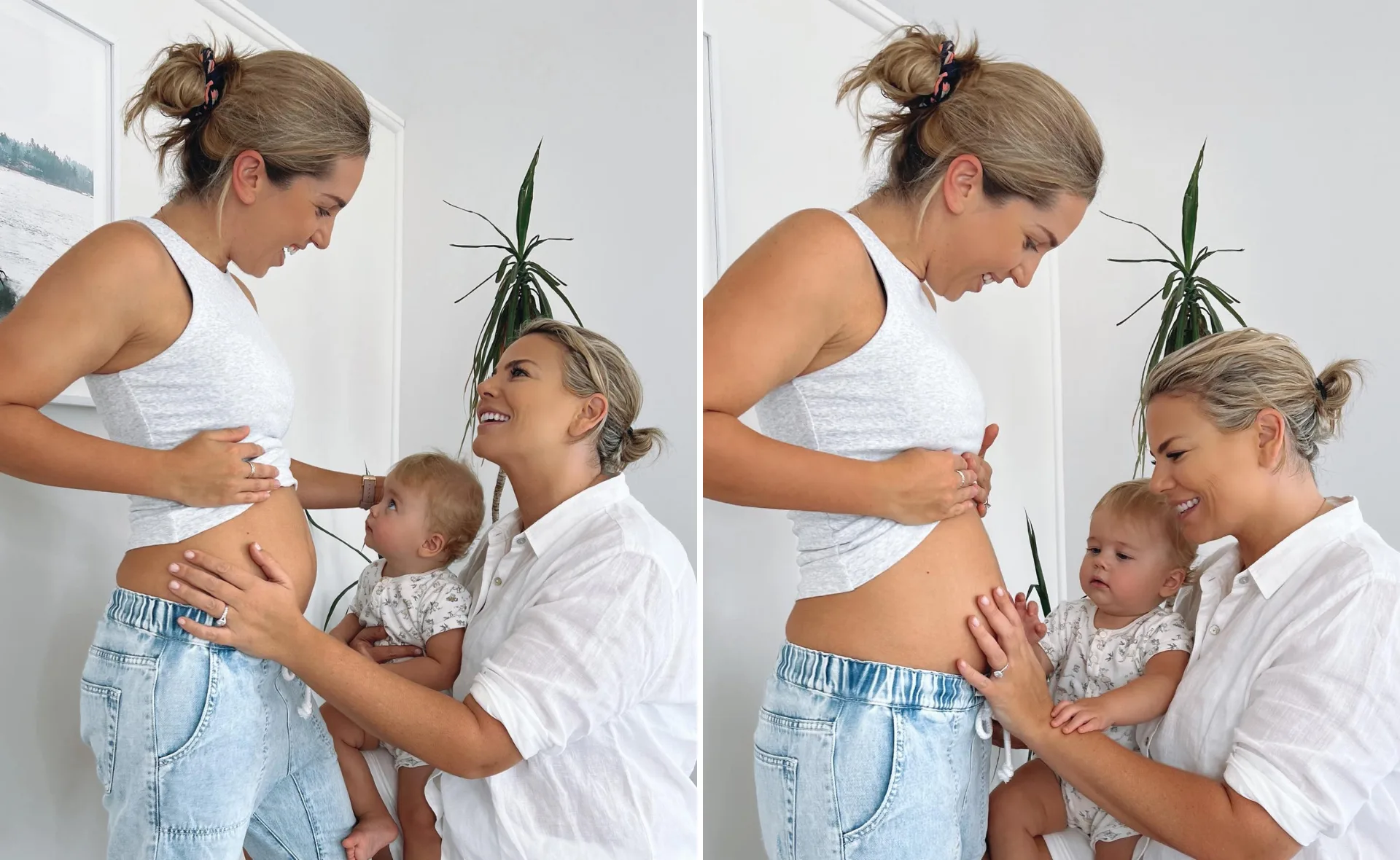 Two women smiling, one pregnant, with a baby on the other's lap, indoors with a plant in the background.