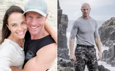 "Couple smiling outdoors; man in camo standing by rocky coast."