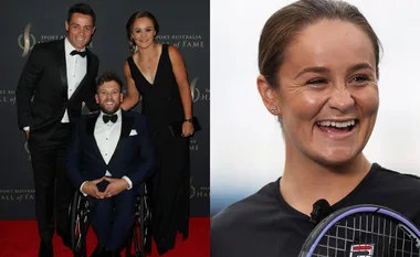 Group at event, in formal wear and smiling; Ash Barty smiling with tennis racket.