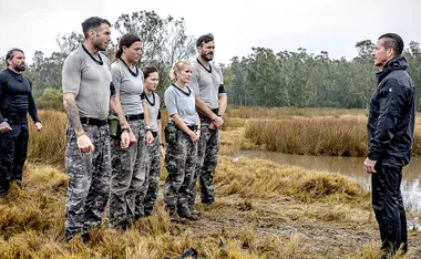 Contestants stand in a line facing an instructor in a muddy field on 'SAS Australia' 2022 finale.