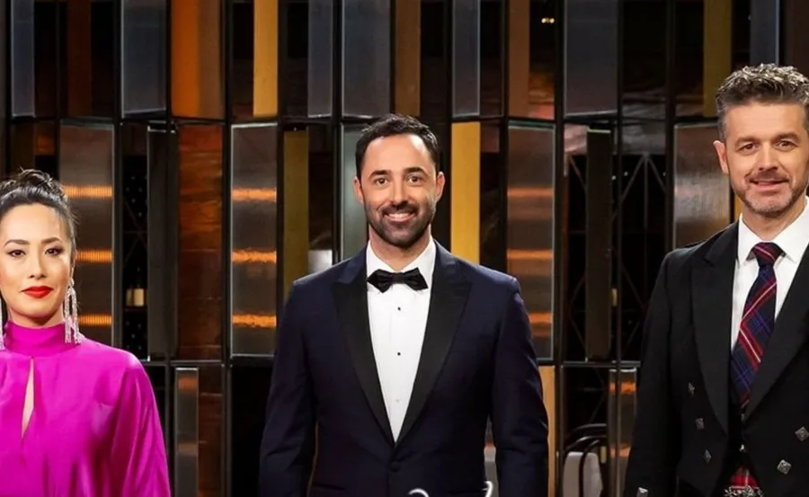 Three judges stand together on set for "MasterChef Fans and Favourites," dressed in formal attire.