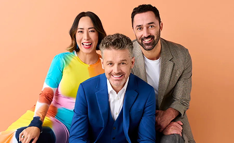 Three judges from MasterChef 2022 smiling against a peach background.