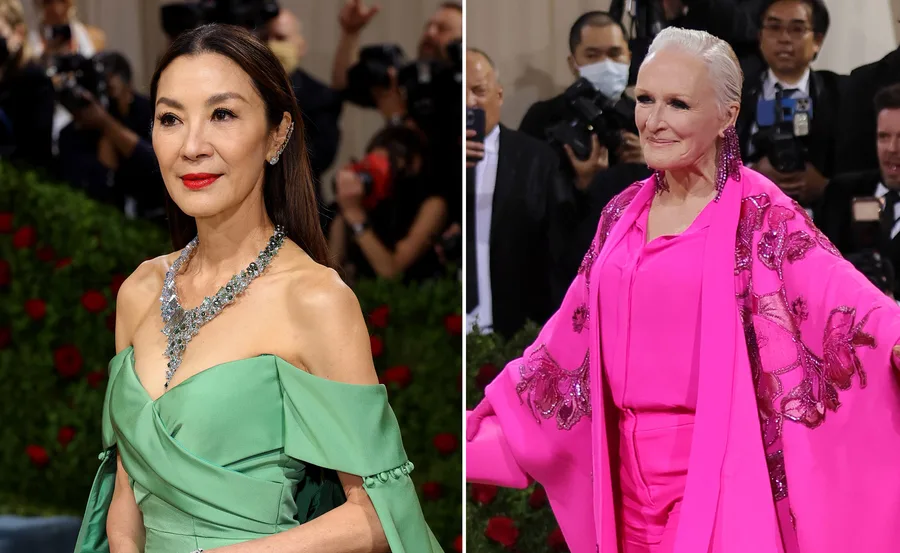 Two women at Met Gala 2022; one in a green gown with silver jewelry, the other in a pink floral-embroidered ensemble.