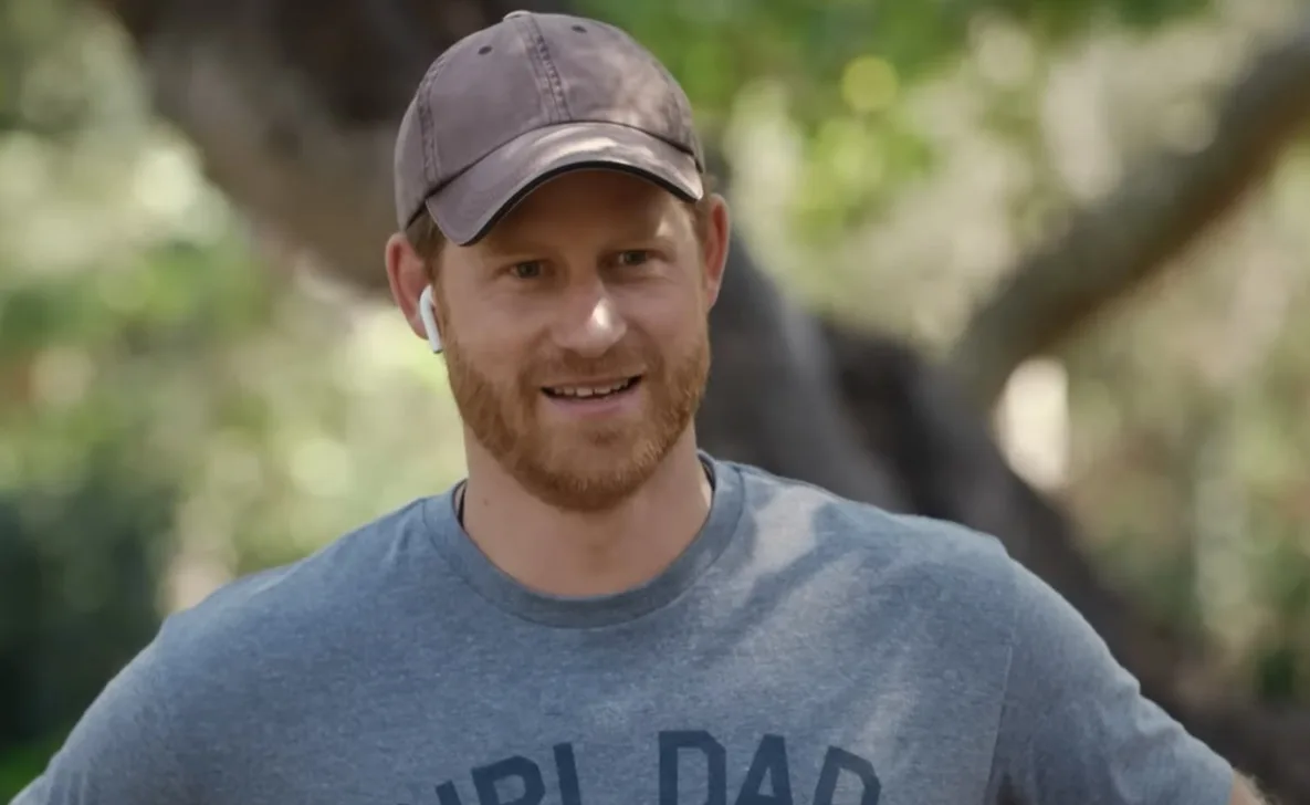 Man with a beard wearing a "Girl Dad" shirt and cap, smiling outdoors.