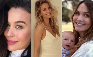 Three women smiling; one with dark hair, one blonde in white dress, one holding a baby outdoors.