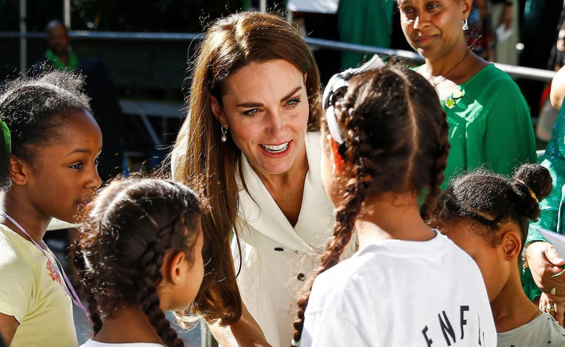 "Kate Middleton engaging with children at Grenfell Tower service event."