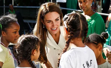 "Kate Middleton engaging with children at Grenfell Tower service event."
