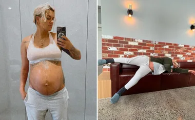 Pregnant Moana Hope in mirror selfie, wearing a sports bra and sweatpants, and reclining on a couch, showing baby bump.