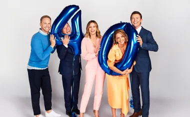 Five people smiling, holding blue "40" balloons, celebrating the 40th anniversary of the Today show.