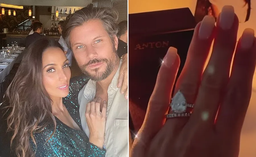A couple poses in a restaurant; a hand is shown close-up with a pear-shaped engagement ring.