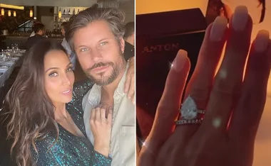 A couple poses in a restaurant; a hand is shown close-up with a pear-shaped engagement ring.