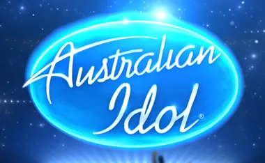 Australian Idol logo in blue and white with a glowing effect, set against a starry night sky background.