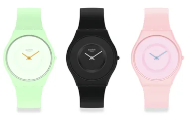 Three Swatch Skin Bioceramic watches in mint green, black, and pink.