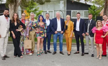 Group photo of "The Block 2022" cast standing outdoors, all dressed in colorful and formal attire.