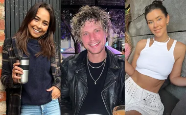 Three people posing: woman with coffee, man in leather jacket, woman in white top and skirt, smiling.