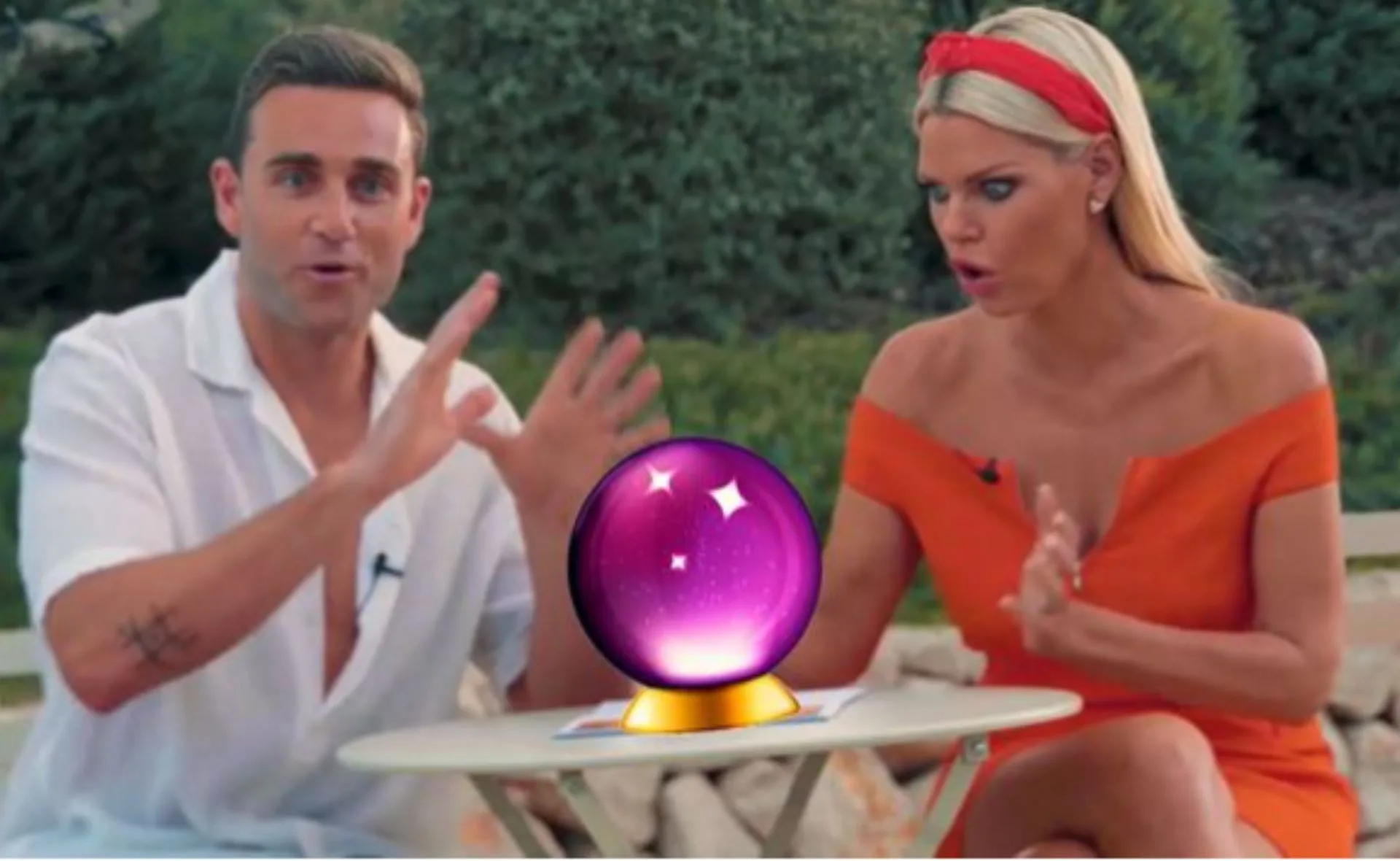 Two people animatedly gesture around a glowing crystal ball on a table outdoors.