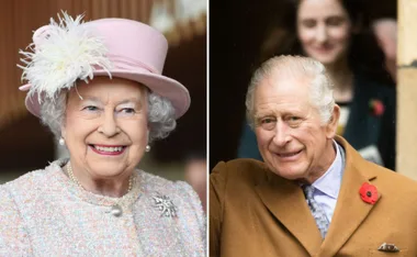 Two older adults, one in a pink hat with feathers, the other in a brown coat with red poppy pin, smiling.
