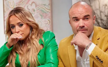 Two individuals sitting, one with blonde hair in a green outfit appears emotional, the other is bald in a yellow jacket.