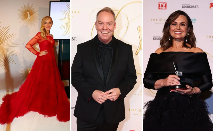 People in formal attire at a red carpet event; a woman in a red dress, a man in a black suit, and a woman with a trophy.