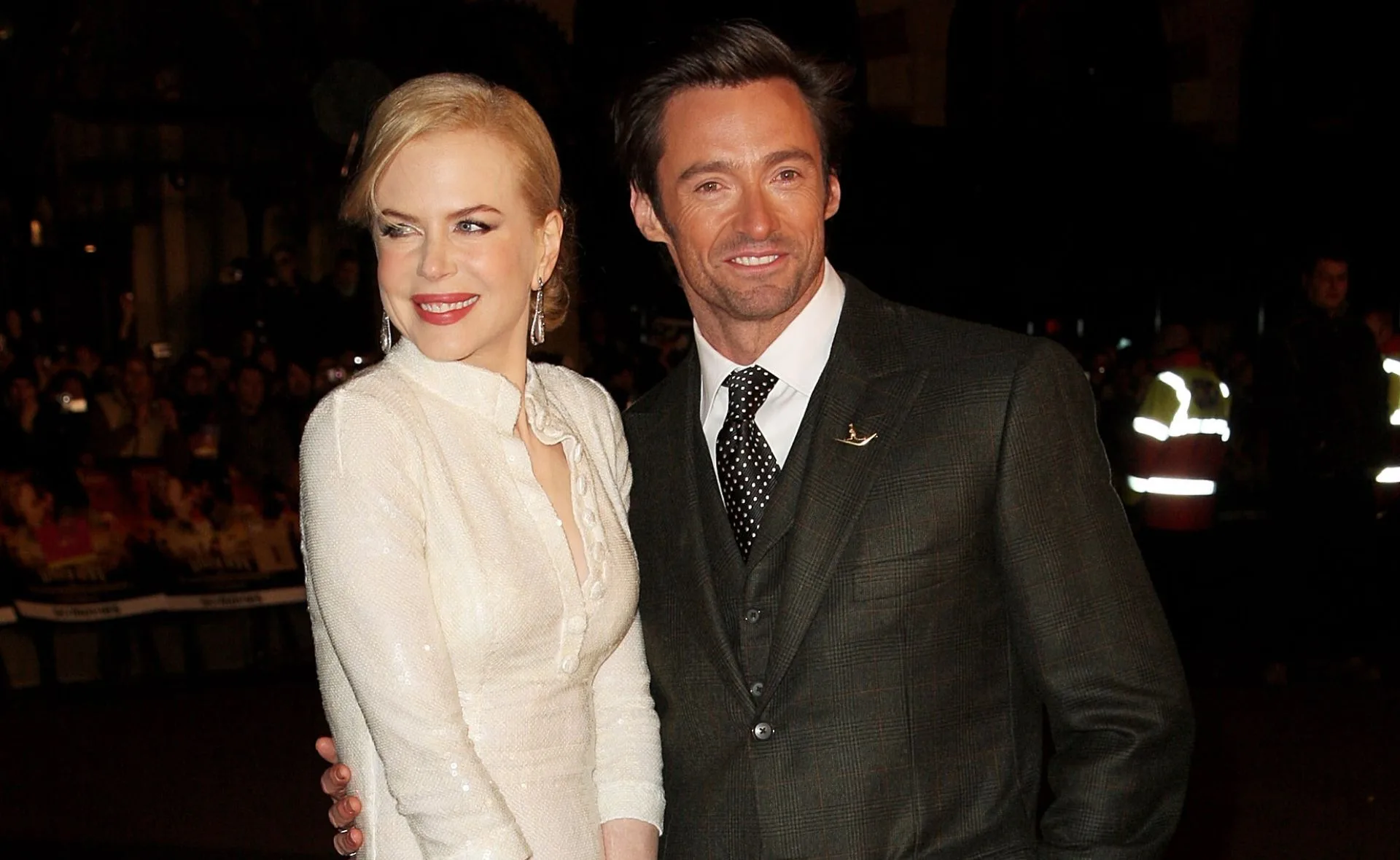 A man and woman smiling and posing together at an event or red carpet.