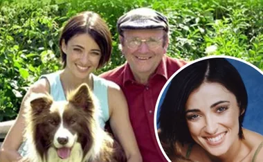 Woman smiling with an elderly man and a dog, outdoor greenery background, inset image of her smiling portrait.