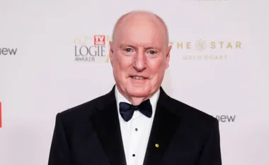 Man in a tuxedo with a bowtie at a Logie Awards event, smiling at the camera.
