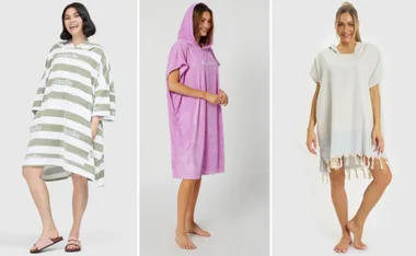 Three women wearing different hooded towel ponchos in various colors and styles.