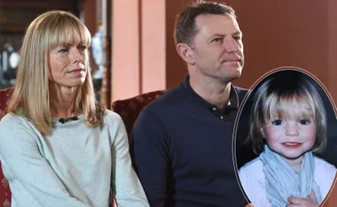 Parents sitting on chairs holding a photo of a young girl in an oval frame.