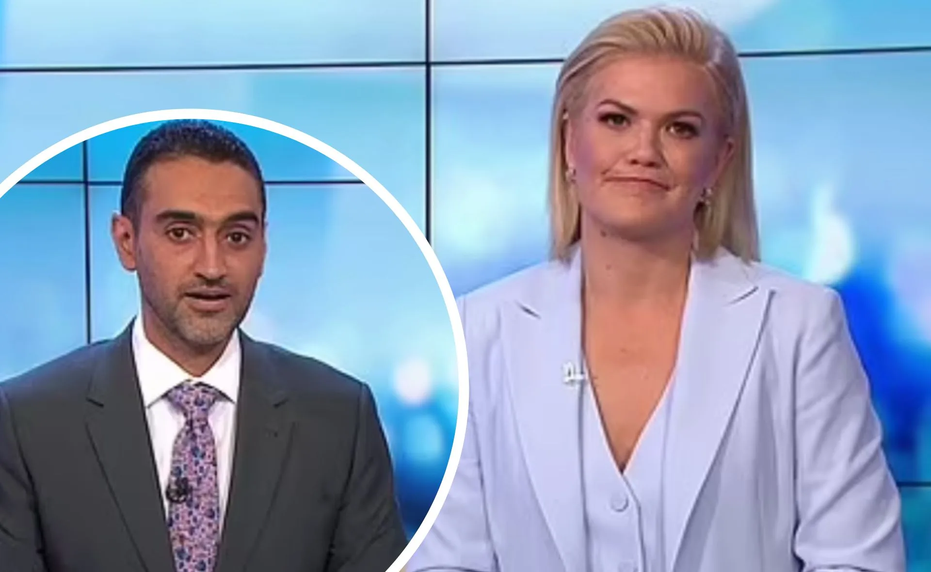 Two news presenters on a TV set, one in a suit with a floral tie and the other in a light blue blazer.