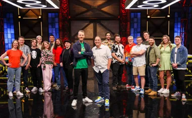 Cast of Lego Masters Australia 2023, featuring contestants and hosts, posed on a stage with colorful lighting.