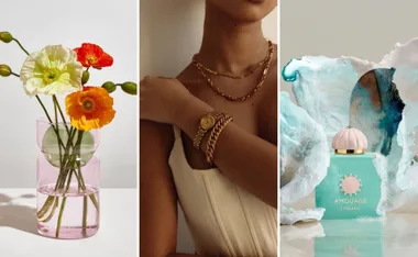A pastel vase with poppies, a woman wearing gold jewelry, and a turquoise Amouage Lineage perfume bottle.
