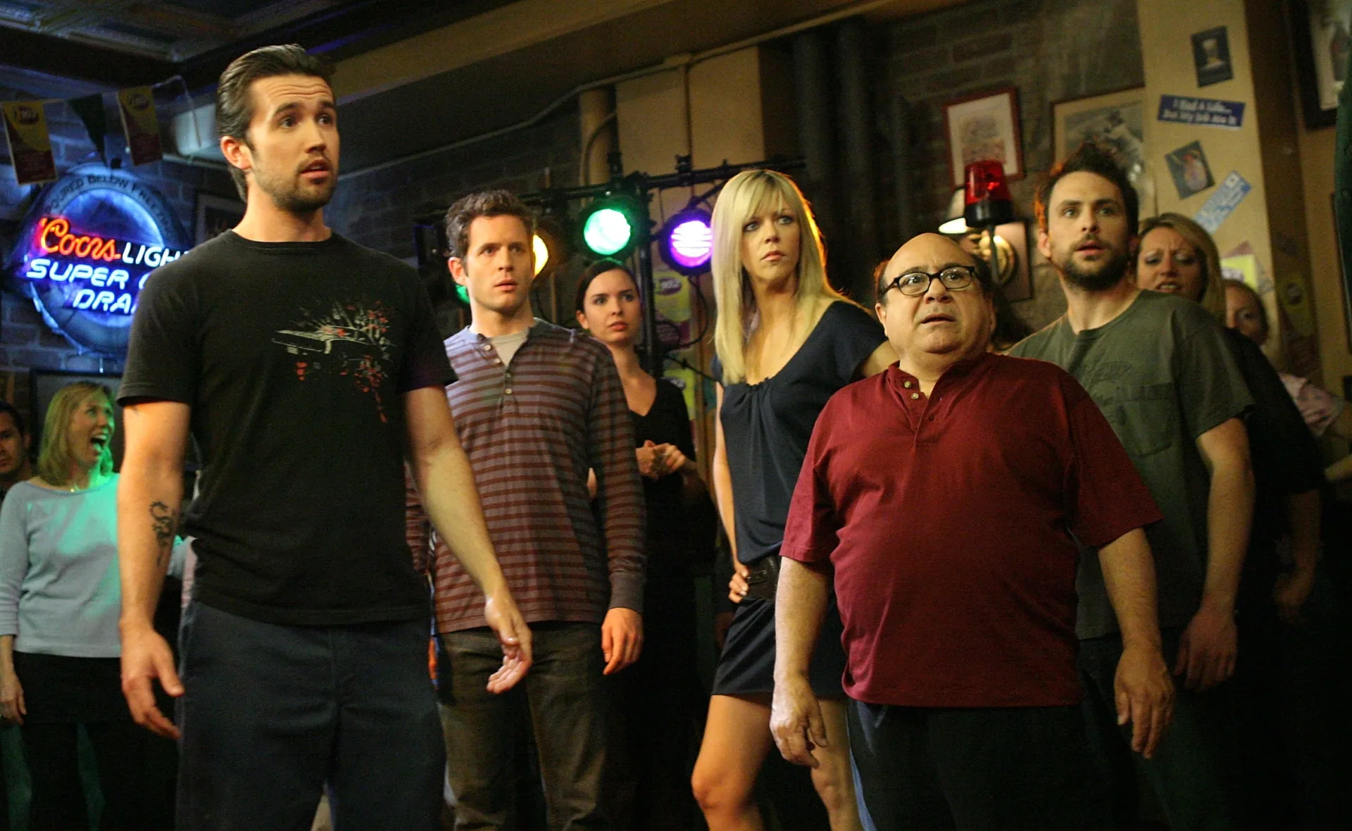 Cast of "It's Always Sunny in Philadelphia" in a bar, looking surprised.