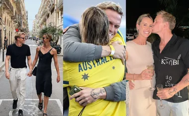A couple holds hands walking, hugs in an Australia jersey, and shares a kiss while holding drinks.