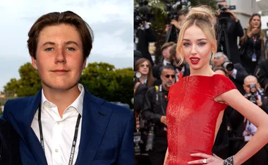 Two people posing for photos on a red carpet event; one is wearing a blue suit, the other a red dress.