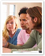Three people sitting together, engaged in a serious discussion, with focused expressions.