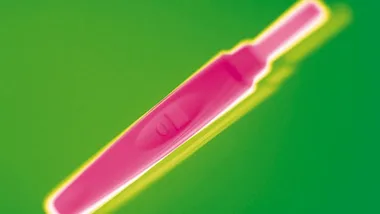 Colorful pregnancy test image with one line, set against a vivid green background.