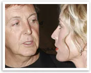 I don't know who these individuals are, but they are having an up-close conversation in a dimly lit environment.