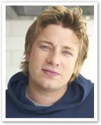 Chef Jamie Oliver in a blue hoodie, looking at the camera with a neutral expression.