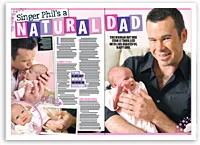 Singer Phil holds a baby lovingly, smiling in a two-page magazine spread titled "Singer Phil's a Natural Dad."