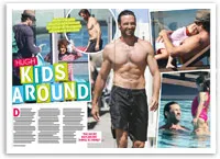 Hugh Jackman enjoys pool time with children, smiling in swim trunks, featured in magazine layout.