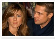 A man and woman having a conversation at a public event with blurred background.