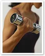 A person in workout attire lifts a dumbbell, focusing on building strength.