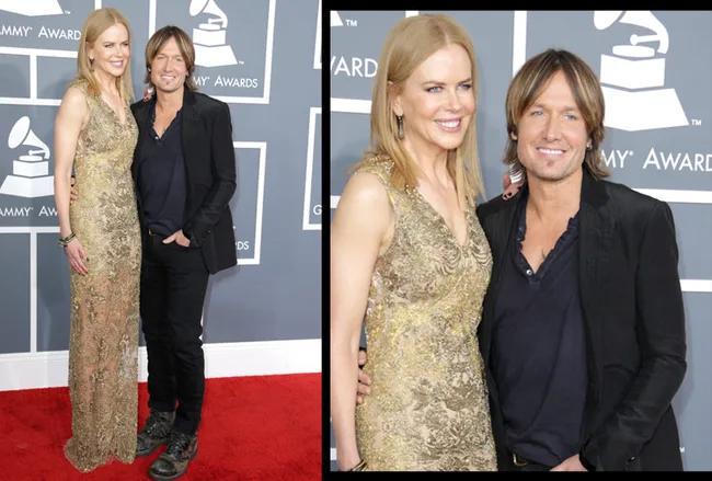 Couple poses on the red carpet at the Grammys, dressed elegantly in a gold dress and dark suit.