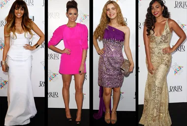 Four women on the ARIA red carpet wearing elegant dresses; white, pink, purple, and gold, posing for photos.