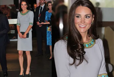 Kate Middleton smiling in a gray dress with green embellishments at a premiere event.