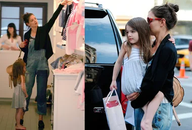 Mother and child shopping, browsing clothes in a store, then exiting with a shopping bag.