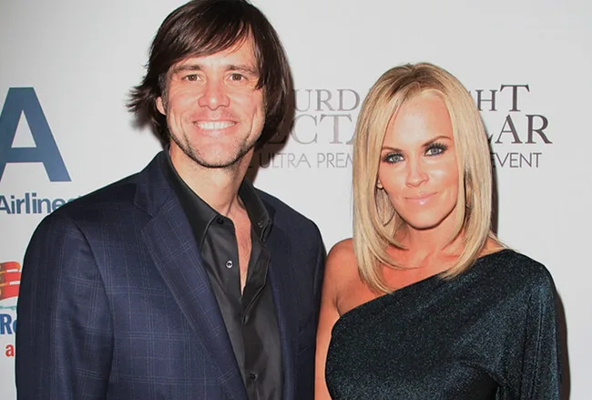 Two people posing together at a formal event, smiling for the camera.