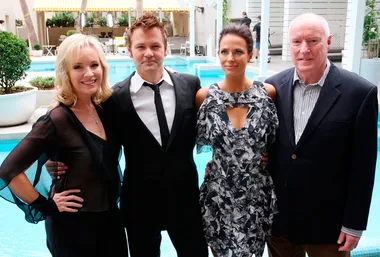 Group of four people posing by a pool, dressed in formal attire, at the 2010 Gold Logie nominees event.