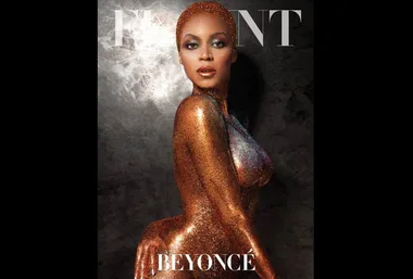 Beyoncé posing in a glittering gold outfit on the cover of a magazine.